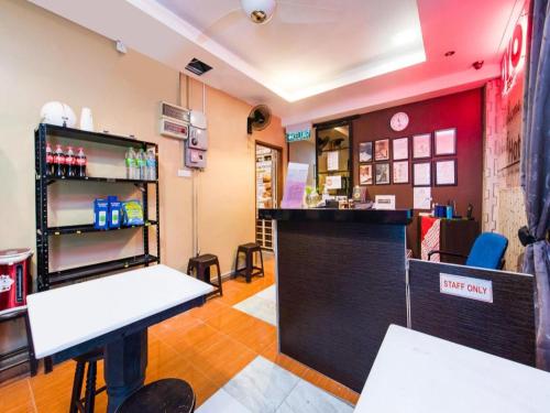 a bar in a restaurant with a counter and chairs at OYO 44123 Hotel Al-Saif in Kuala Kerai