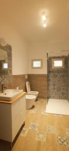 a bathroom with a toilet and a tub and a sink at ROMANTICA TOSCANA in Scarlino