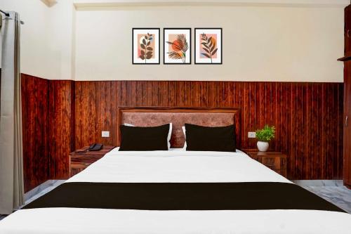 a bedroom with a large white bed and wood paneling at Super Collection O Matiyari in Lucknow