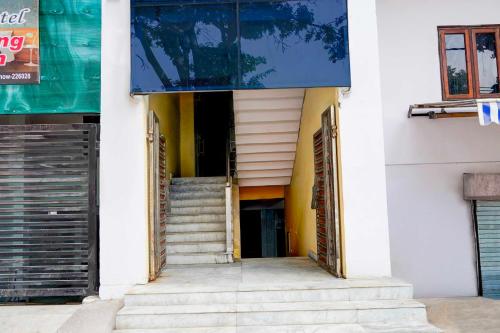 an entrance to a building with stairs and a blue awning at Super Collection O Matiyari in Lucknow