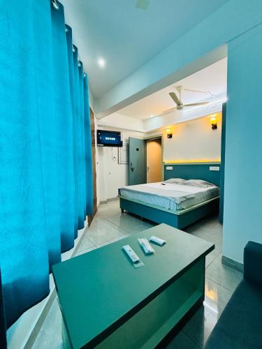 a bedroom with a bed and a table with two remote controls at Hotel Minar in Rohtak