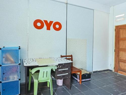 a room with a table and a sign on the wall at OYO 90315 Chalet Pantai Rantau Panjang in Kuala Rompin