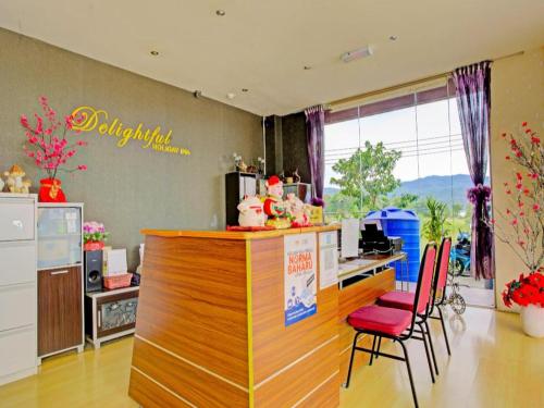 a kitchen with a bar with a colorful counter at OYO 90597 Delightful Holiday Inn in Ranau
