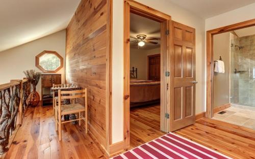 a bathroom with a shower and a wooden wall at Wine Down Cottage - Mountain Views Sip Wine Fireside Watch Netflix Play Golf in Jasper