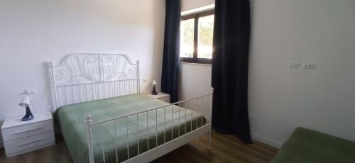 a small bedroom with a bed and a window at ROMANTICA TOSCANA in Scarlino