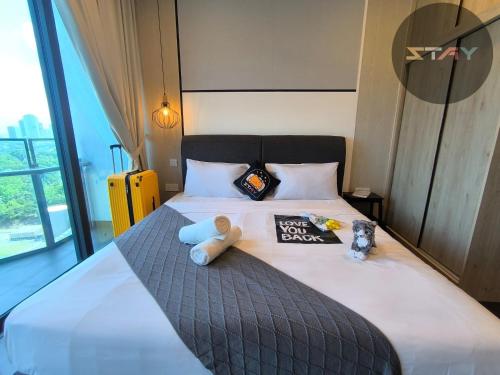 a bedroom with a bed with a teddy bear on it at Almas Couple Relax Modern Comfort Netflix BySTAY in Nusajaya