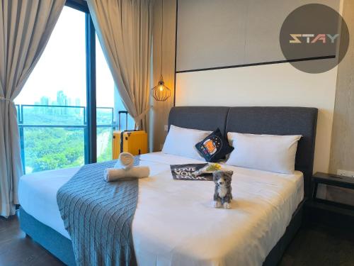 a bedroom with a bed with a teddy bear on it at Almas Couple Relax Modern Comfort Netflix BySTAY in Nusajaya
