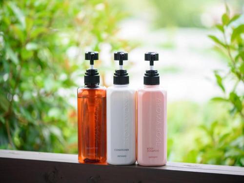 three bottles of soap sitting on a ledge at Yufuin Matousou in Yufuin