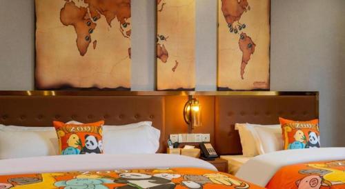 two beds in a hotel room with paintings on the wall at James Joyce Coffetel·Lijiang Old Town Centeral in Lijiang