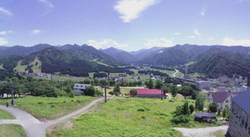 a view of a town with mountains in the background at Hotel Alphastar Iwappara in Yuzawa