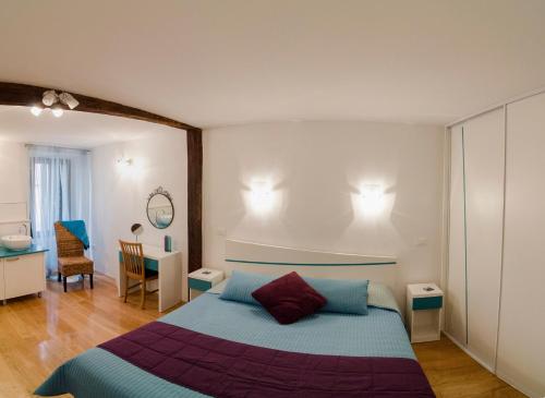 a bedroom with a bed and a desk and a chair at Apartment Sea View in Rovinj