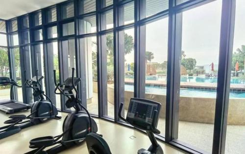 a room with a gym with a view of a pool at Almas Couple Relax Modern Comfort Netflix BySTAY in Nusajaya