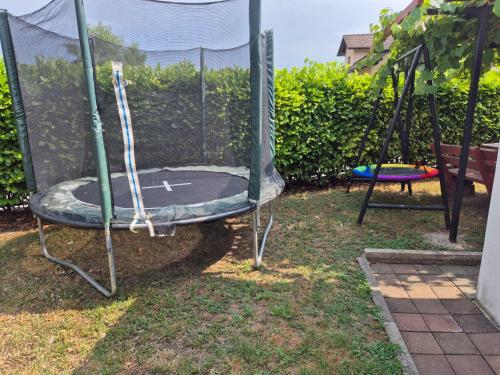an empty trampoline in a yard with a trampoline at Hana Superior Apartments in Bihać