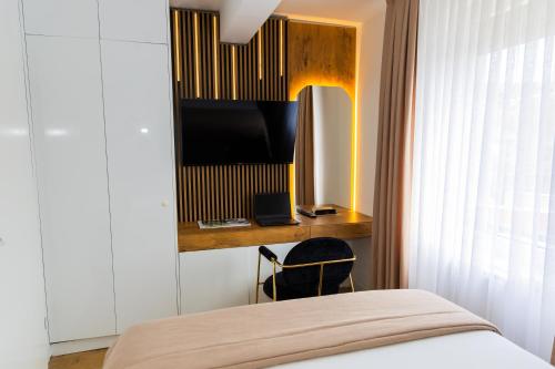 a bedroom with a bed and a television on a wall at Urban Studio II 
