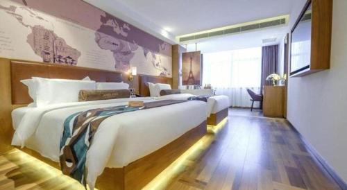a hotel room with two beds and a map on the wall at James Joyce Coffetel Shenyang North Railway Station Qishan Road Metro Station in Shenyang