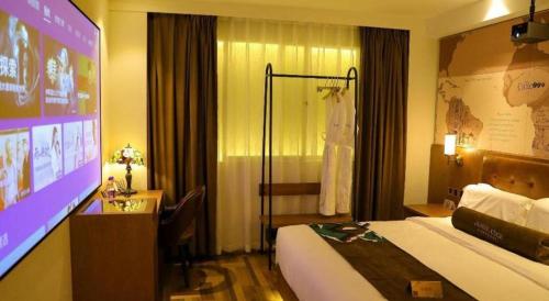 a hotel room with a bed and a large screen at James Joyce Coffetel Shenyang North Railway Station Qishan Road Metro Station in Shenyang