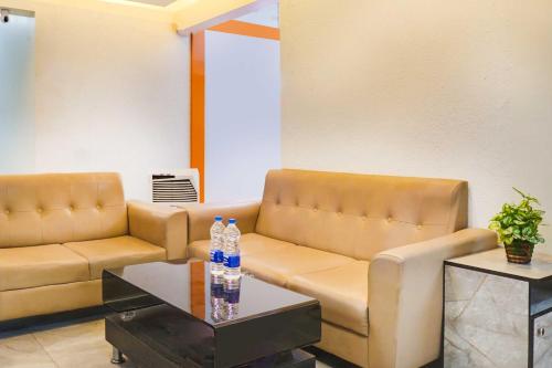 a waiting room with a couch and a table at Collection O Lohegaon Pune Airport in Pune
