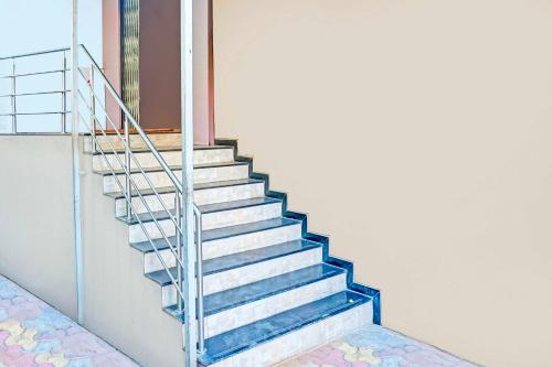 a staircase in a building with a metal railing at Collection O Pune Nagar Road Viman Nagar in Pune