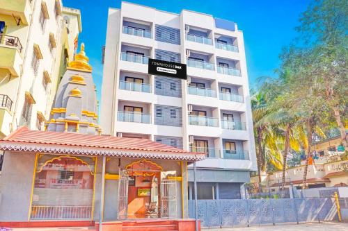 a building with a pagoda in front of a building at Townhouse Oak Amanora Mall in Pune
