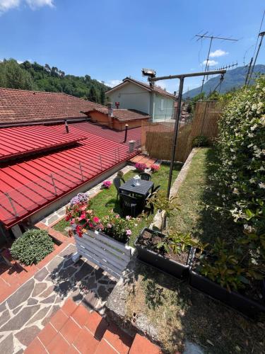a garden with a bench and flowers on a patio at Al Casello in Barga