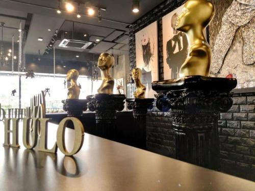 a group of gold statues sitting on top of a table at The Hulo Hotel & Gallery in Kuala Lumpur