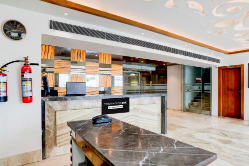 a lobby with a counter in a building at Townhouse Oak Ahmedabad Junction in Ahmedabad