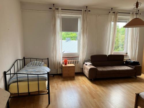 a living room with a couch and a bed at Dähre Wohnung 3 in Niederdorla