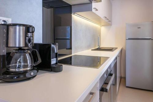 a kitchen with a coffee maker and a refrigerator at Sunset Serenity Villas with onsite pool and only 3min from beach in Drage