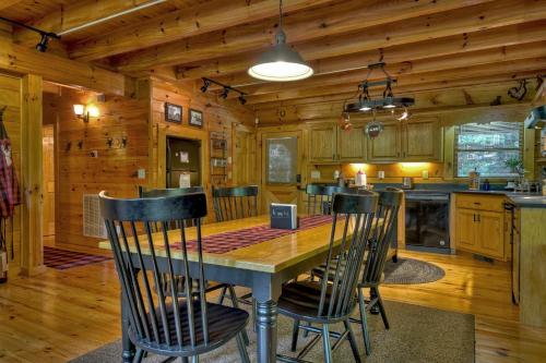 a dining room and kitchen with a table and chairs at Buffalo Ridge Fish in the pond soak in the hot tub in Mineral Bluff