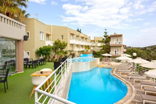 a view of a pool at a hotel with chairs and umbrellas at Pelagia Bay Hotel in Agia Pelagia