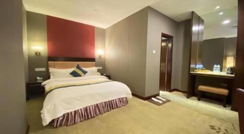 a bedroom with a large bed and a bathroom at Shunde Emperor Hotel in Shunde