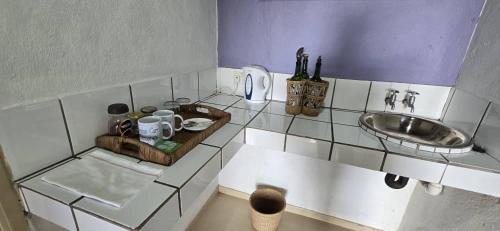 a small kitchen with a sink and a counter top at Norman Carr Cottage in Monkey Bay