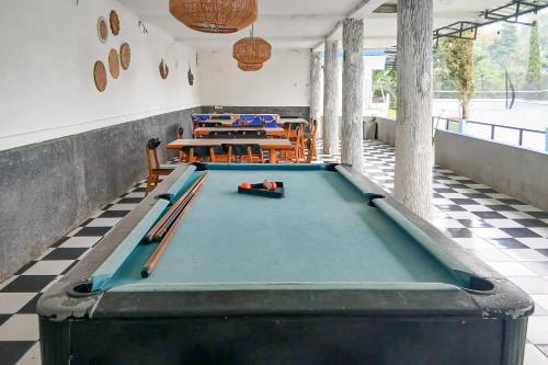 a room with a pool table with bats on it at Pangrango Valley Resort RedPartner in Situ 2