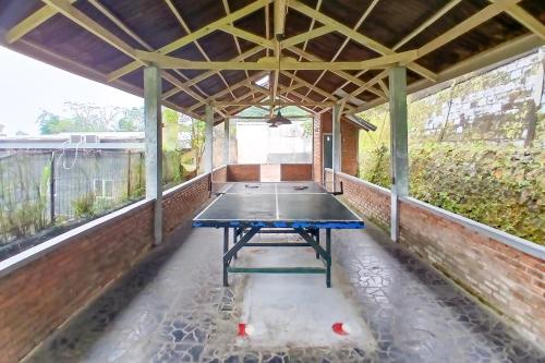 a ping pong table in a covered patio at Pangrango Valley Resort RedPartner in Situ 2