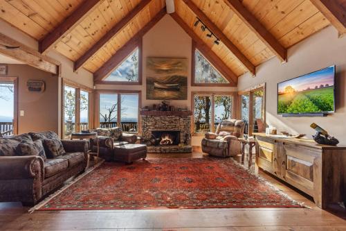 a living room with a fireplace and a tv at Canoe Believe It - Enjoy mountain views cook out on the Weber grill relax in Jasper