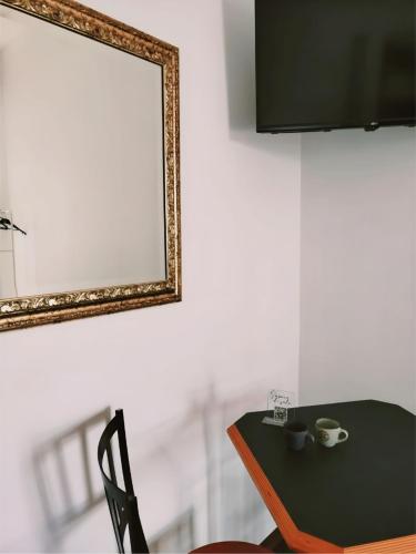 a table with a mirror and a table with a chair at Sapore di Sale - Casa Vacanza a Pizzo Calabro in Pizzo
