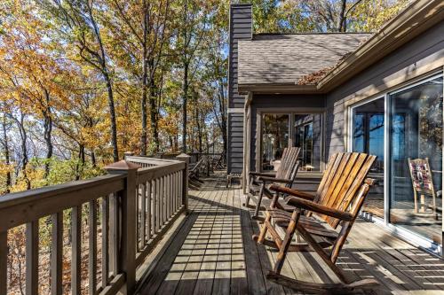a deck with rocking chairs on a house at Canoe Believe It - Enjoy mountain views cook out on the Weber grill relax in Jasper