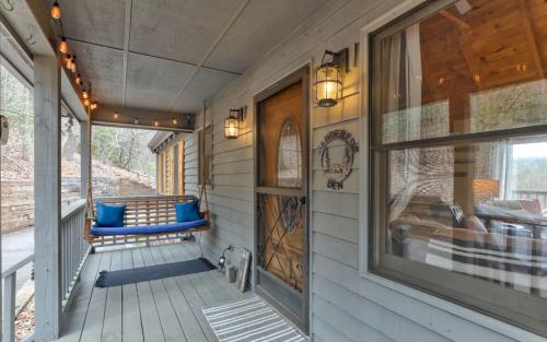 a porch with a blue bench and a window at Wanderers Den - Peaceful mountain views Wifi and homey comforts in Jasper