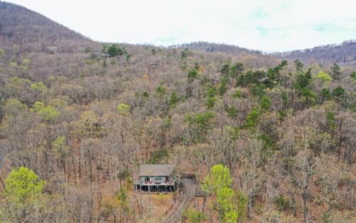 an aerial view of a house in the middle of a forest at Wanderers Den - Peaceful mountain views Wifi and homey comforts in Jasper