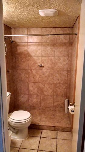 a bathroom with a toilet and a shower stall at Lake Powell Canyon Inn in Page