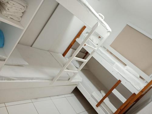 a staircase in a room with white shelves at Palm Village Acqua in Porto De Galinhas