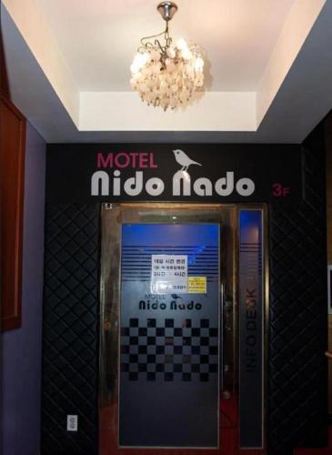 an elevator in a building with a sign on the wall at Nidonado Motel in Seoul