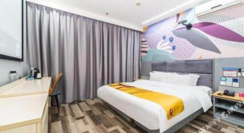 a bedroom with a bed and a wall with an umbrella mural at Pai Hotel Xi'an Electronic Zheng Street in Xi'an