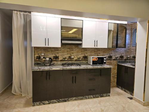 a kitchen with white cabinets and a counter top at villa 100C A2 in Sharm El Sheikh