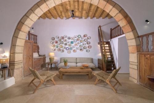 a living room with a couch and a table and chairs at White House 1871 in Lachania
