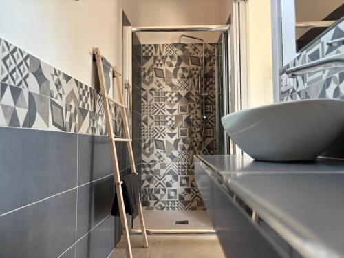 a bathroom with a sink on a counter next to a shower at Casa MaLù in Aci Bonaccorsi