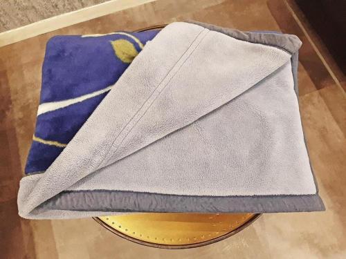 a pile of towels sitting on top of a table at Hotel Areaone Miyazaki in Miyazaki