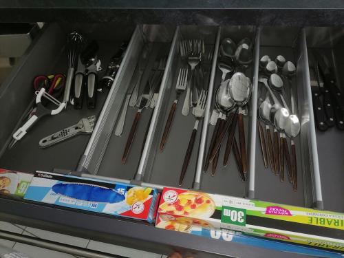 a drawer filled with utensils on a shelf at Le Tiot Saint Martin in Auxi-le-Château