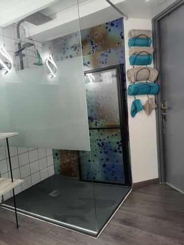 a shower with a glass door in a bathroom at Le Tiot Saint Martin in Auxi-le-Château