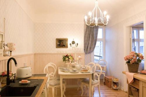 a kitchen with a table and chairs and a dining room at Villa Tammsaare Deluxe Beach Apartment in Pärnu